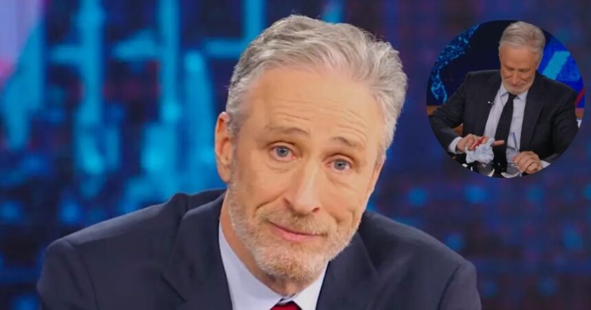 Jon Stewart on The Daily Show Hero Image: Stewart in his Daily Show seat [Credit: Comedy Central] Inset (Circle) Image: Moment of the mug smash [Credit: The Daily Show/X]